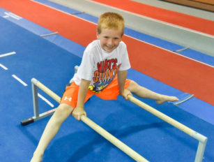 Boy straddling two bars