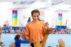 Girl giving high fives in class