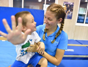 Toddler with a coach in class