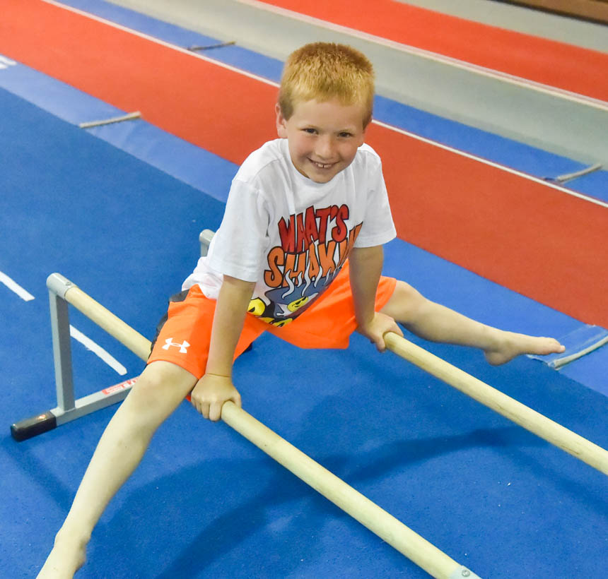 Boy straddling two bars